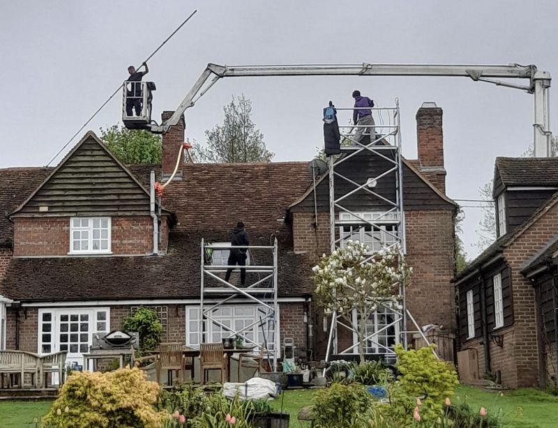 The Roof Moss Cleaners using cherry picker and scaffolding to clean roof safely and professionally in Hertford, Hertfordshire